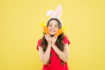 Healthy food is healthy life. healthy childhood. good for your teeth. Nibbles carrot like hare. kid in rabbit ears love eating carrot. child bunny with carrot. little happy girl food for rabbits