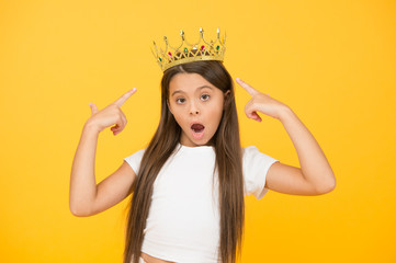 completely egoist. surprised child in queen crown. rich royal accessory. dream about future wealth....