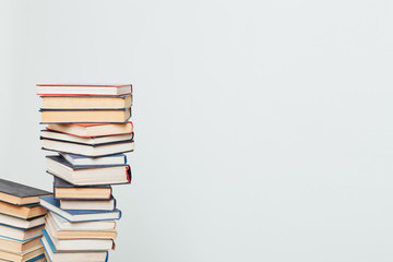 many stacks of educational books at home preparing for exams on a white background