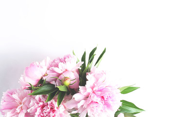 bouquet of light pink peonies on a white background. close-up view from the top, copy space
