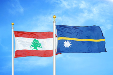 Lebanon and Nauru two flags on flagpoles and blue cloudy sky