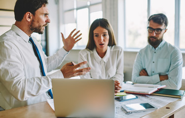 Tired office workers feeling headache during deadline reading email with bad news from colleague...