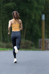 A young Asian woman is running