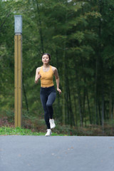 A young Asian woman is running
