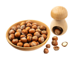 Hazelnuts in a wooden bowl isolated on white background, top view