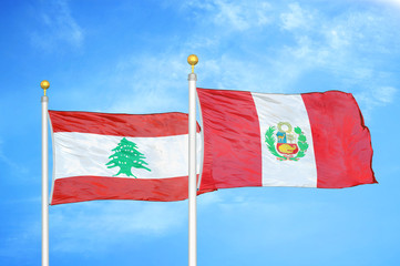 Lebanon and Peru two flags on flagpoles and blue cloudy sky
