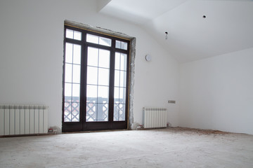 Unfinished apartment interior. The apartment is under construction and renovation. Unfinished repairs in a private house. The living area is unfinished.