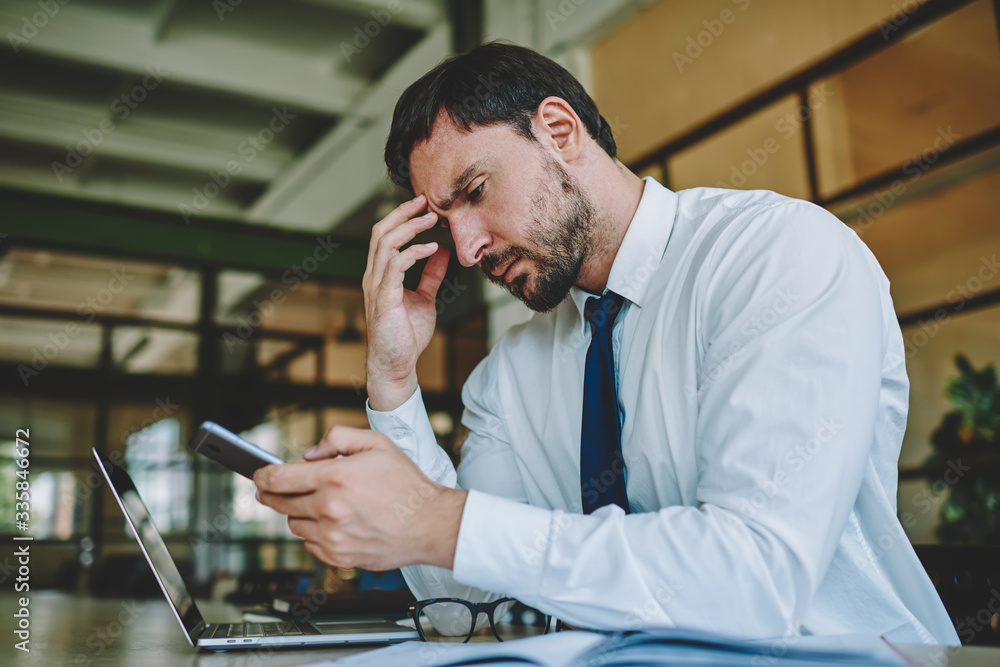 Poster puzzled male employer sending email message to customer via application on cellular connected to wif