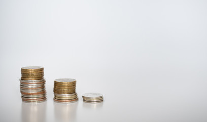 Three stacks of coins of different heights on a gray background: banner, text space, financial concept, Bank and loans