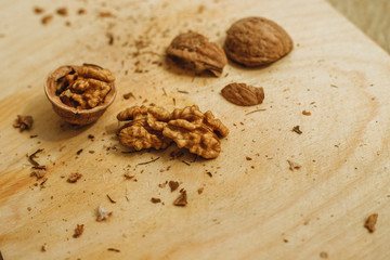 Walnuts, broken shells. Nut kernels on a wooden Board. Close up. Background or texture.