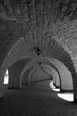 arched curved brick tunnel under a pier