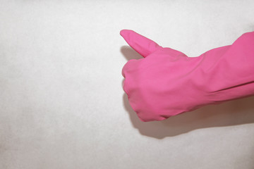 Pink household glove on hand shows super on a white background for cleaning