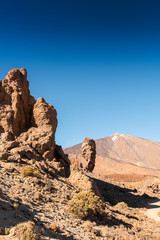 Fototapeta premium Roques de Garcia, with volcano Teide in the background, in Teide National Park, Tenerife, Canary Islands, Spain