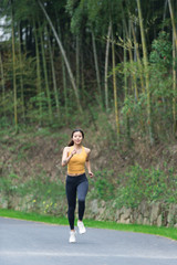 A young Asian woman is running