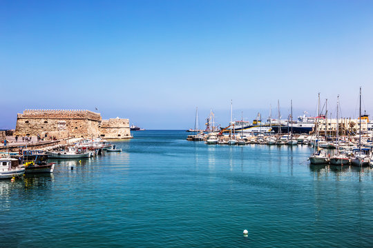 View of the medieval sea fortress Coules and the old port on a sunny summer day. Heraklion, Crete, Greece