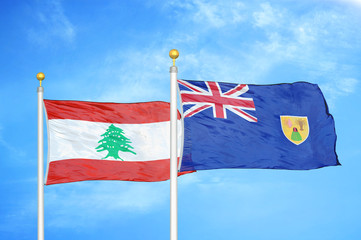 Lebanon and Turks and Caicos Islands two flags on flagpoles and blue cloudy sky