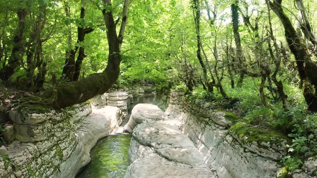 The Kinchkha waterfall in the canyon of the river Okatse. Rest in Georgia. High waterfall in the Imereti region. Rocky ledges of the mountain with green trees.