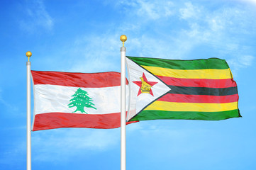 Lebanon and Zimbabwe two flags on flagpoles and blue cloudy sky