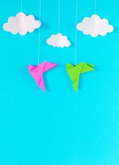 blue background with birds and clouds on a rope of paper