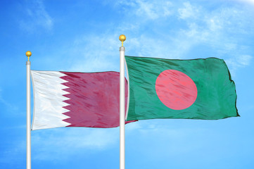 Qatar and Bangladesh  two flags on flagpoles and blue cloudy sky