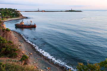 Scenic landscape of Black Sea coast by Bolshoy Utrish village, Anapa, Russia. Wave splashing on pebble beach at sunset.