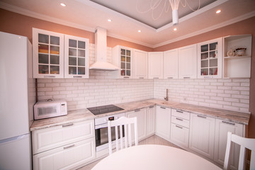 Kitchen interior the room, modern kitchen, a kitchen background, the concept of healthy food, an interior of modern kitchen in beige, brown and white tones with a white brick