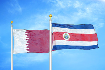 Qatar and Costa Rica two flags on flagpoles and blue cloudy sky