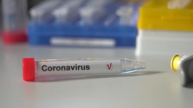 coronavirus test. Test tube lying on inspiratory protective respiratory mask. COVID-19 test or SARS-CoV-2 test. Stop spreading