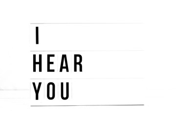 I Hear you flat lay on a white background. Love and relationship Vintage Retro quote board