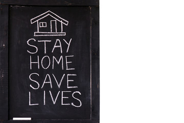 "Stay home save lives" slogan due to Coronavirus pandemic outbreak around the world. Coronavirus Covid-19, quarantine motivational phrase. Stay home concept written on blackboard.