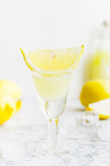 Italian traditional liqueur limoncello with lemon