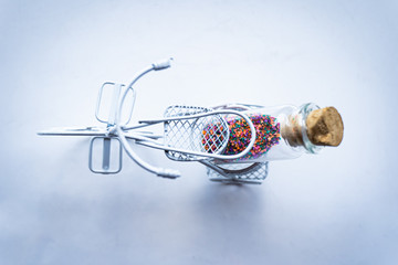 Bicicleta decorativa con frasco de vidrio lleno de arena de colores