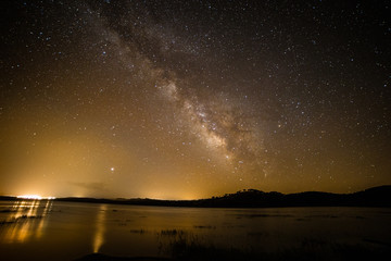 Fototapeta na wymiar Night sky with stars and Milky Way over mountain lake