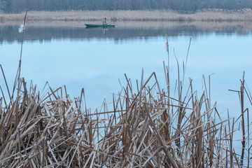 Fisherman catches fish in a quiet river
