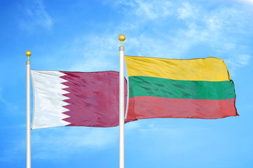 Qatar and Lithuania two flags on flagpoles and blue cloudy sky