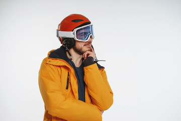 Obraz premium snowboarder in the mask and helmet on a white background. Man is trying to decide: snowboarding or skiing