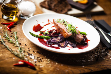 Duck breast served on a plate in restaurant