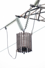 Line traps, also called wave traps, suspended under a high voltage power line pylon.