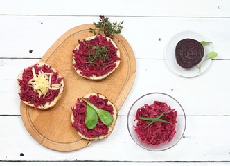 Homemade sandwich with red beetroot, flat lay.  Made from common beetroot, mayonnaise, cheese and herbs