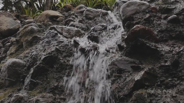 water is running trough big crack in basalt boulder