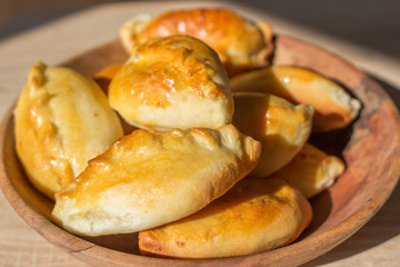 Baked cakes. Yeast baking. Pies with meat, cabbage and mushrooms. Homemade food. Slavic cuisine. Delicious pastries. Ruddy snack. Flour product. Bake in the oven. Junk food.