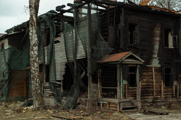 A dilapidated wooden house after a fire