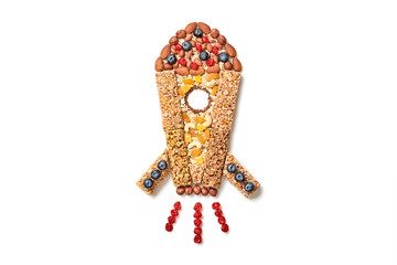 Rocket from granola bar with nuts, dry fruit berries. Energy power sign. Fitness diet super food....