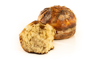 A homemade baked loaf of round artisan white sourdough bread isolated on white.