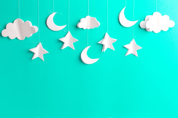Mint background with new moon, stars and clouds of paper, handmade
