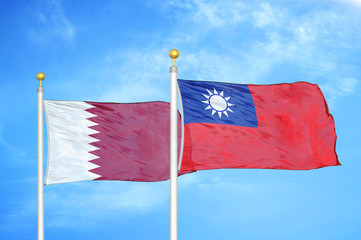 Qatar and Taiwan two flags on flagpoles and blue cloudy sky