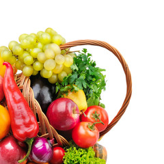 Vegetables and fruits in a basket isolated on white background. Free space for text.