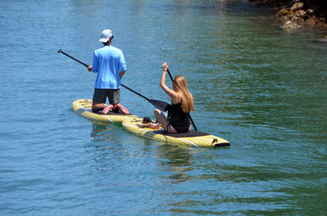Young couple paddle boarding 