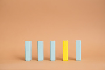 Row of five blank wooden blocks. Four blue blocks and one yellow