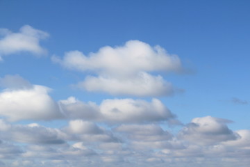 Lovely white fluffy clouds on a background of blue sky.